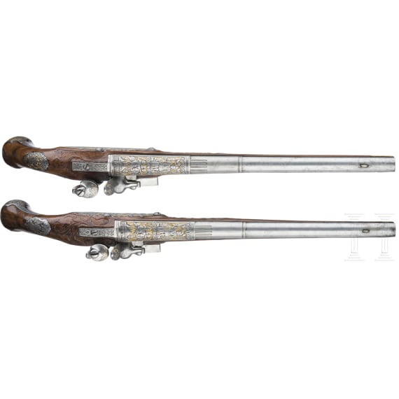 A magnificent pair of German chiselled flintlock pistols, circa 1780