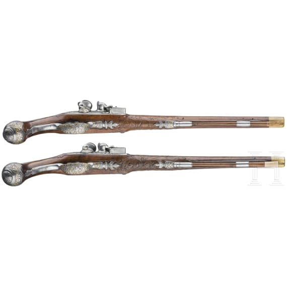 A magnificent pair of German chiselled flintlock pistols, circa 1780