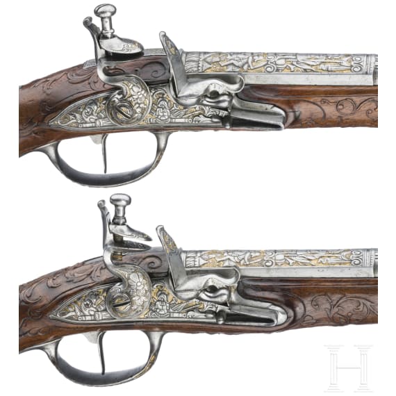 A magnificent pair of German chiselled flintlock pistols, circa 1780