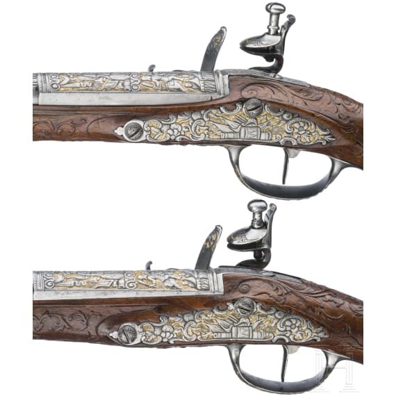 A magnificent pair of German chiselled flintlock pistols, circa 1780