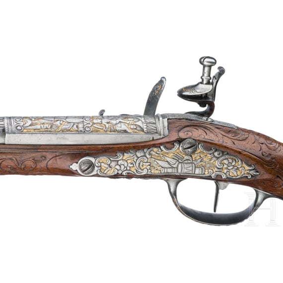 A magnificent pair of German chiselled flintlock pistols, circa 1780