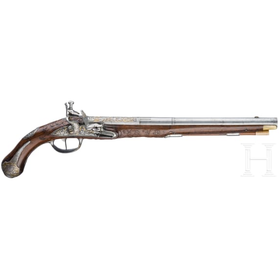 A magnificent pair of German chiselled flintlock pistols, circa 1780
