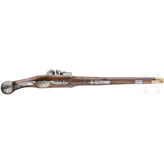 A magnificent pair of German chiselled flintlock pistols, circa 1780