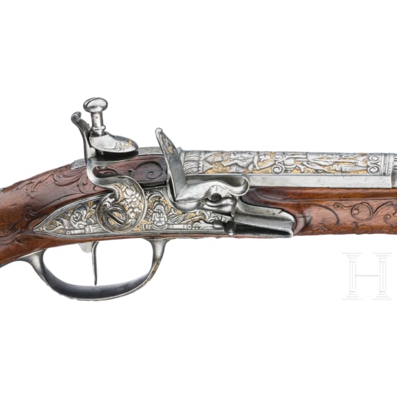 A magnificent pair of German chiselled flintlock pistols, circa 1780