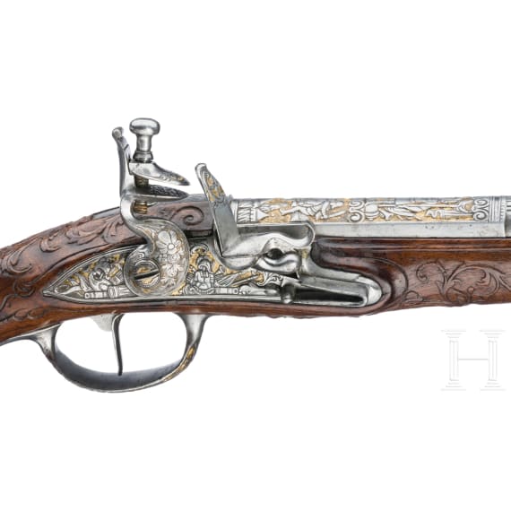 A magnificent pair of German chiselled flintlock pistols, circa 1780