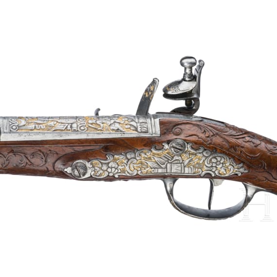 A magnificent pair of German chiselled flintlock pistols, circa 1780
