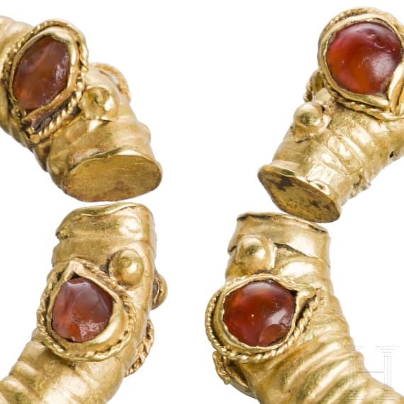 Two Greek golden curl rings with stylized animal heads, mid-4th century B.C.