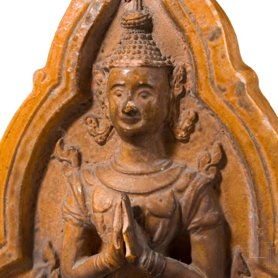 An orange-glazed front of a Thai roof tile (end of a monk tile) decorated with a temple guardian, circa 1900