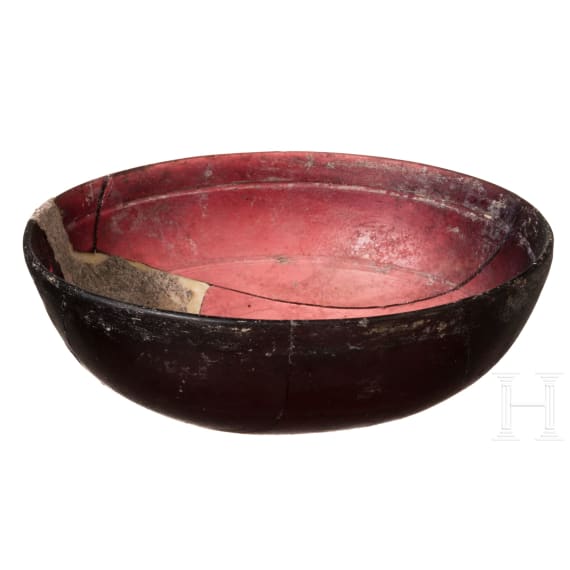 A Roman aubergine-coloured glass bowl, late 1st century B.C. - early 1st century A.D.
