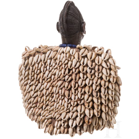 A Nigerian female twin figure (ere ibeji) of the Yewa in a cowry cloak, Nigeria, 20th century