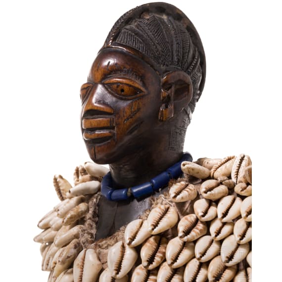 A Nigerian female twin figure (ere ibeji) of the Yewa in a cowry cloak, Nigeria, 20th century
