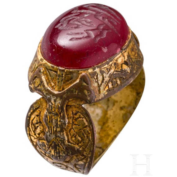 An ornate and gilt bronze ring with inscribed carnelian cabochon, Seljuk, 12th - 13th century