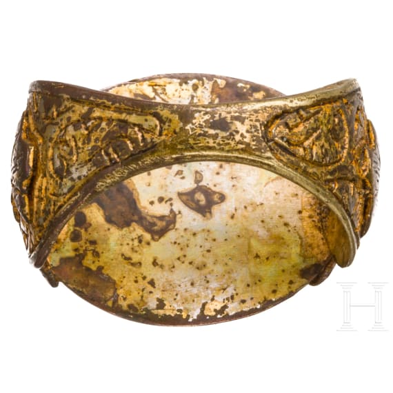 An ornate and gilt bronze ring with inscribed carnelian cabochon, Seljuk, 12th - 13th century