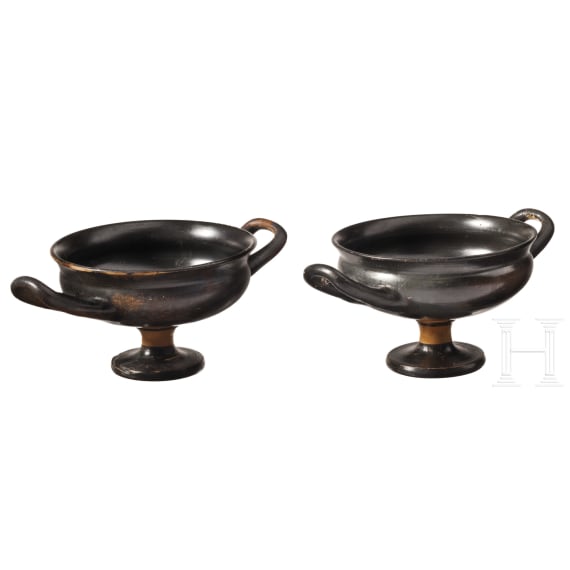Two Greek bowls with handles made of black-glazed pottery, 4th century B.C.