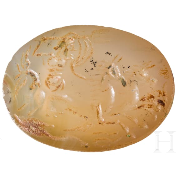 A Greek agate stone gem with Poseidon in biga drawn by two hippokamps, 4th century B.C.