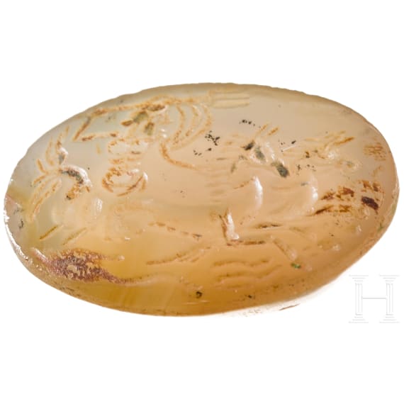 A Greek agate stone gem with Poseidon in biga drawn by two hippokamps, 4th century B.C.