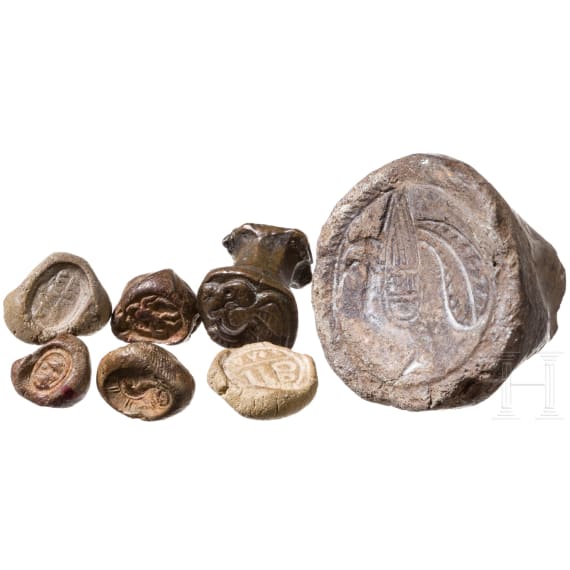 Five impressions of seals on clay, a clay model and a bronze punch with bird of prey, Greek, late antique and early Islamic, 3rd century B.C. - 8th century A.D.