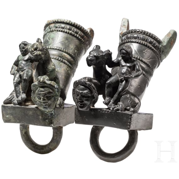 Two Roman mirror-like yoke fittings with Eros on panther and satyr mask, bronze, late 1st - mid-3rd century A.D.
