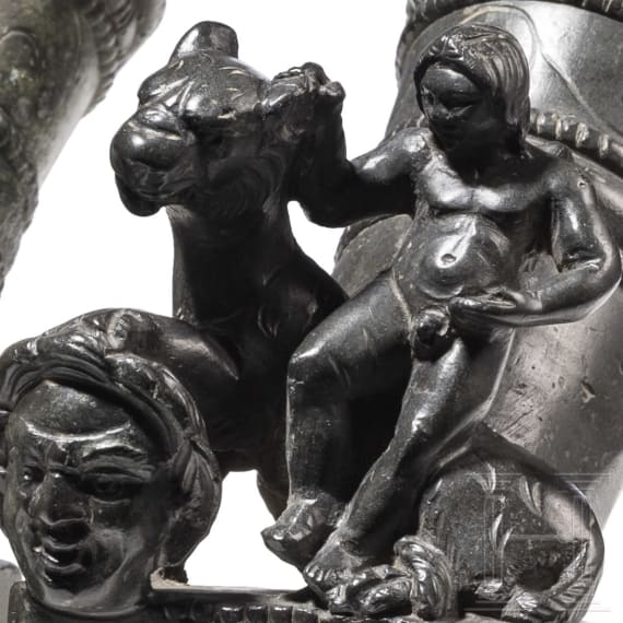 Two Roman mirror-like yoke fittings with Eros on panther and satyr mask, bronze, late 1st - mid-3rd century A.D.