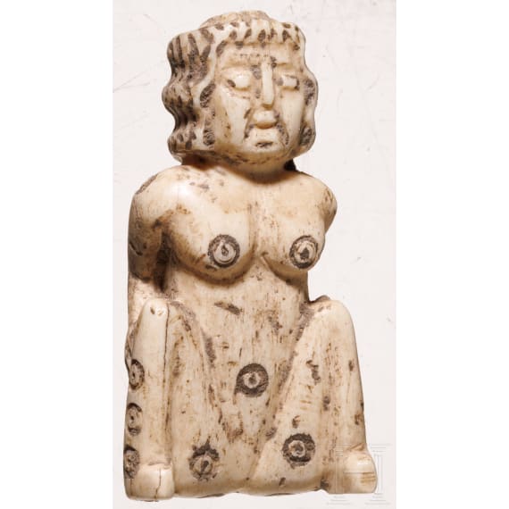 A Roman erotic gambling bone dice in the shape of a squatting woman, 2nd - 3rd century A.D.