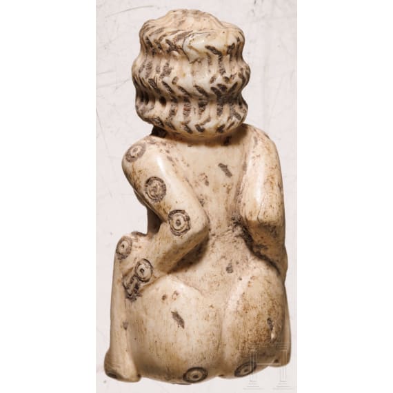 A Roman erotic gambling bone dice in the shape of a squatting woman, 2nd - 3rd century A.D.