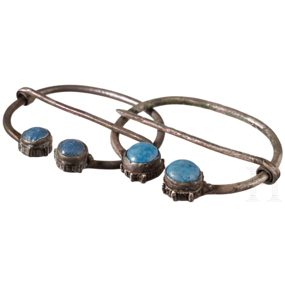 A pair of Finno-Ugric ring brooches made of silver with blue glass inlays, 10th - 11th century