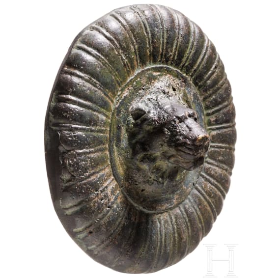 A solid bronze appliqu&eacute; with a central lion head based on an antique model, 19th century