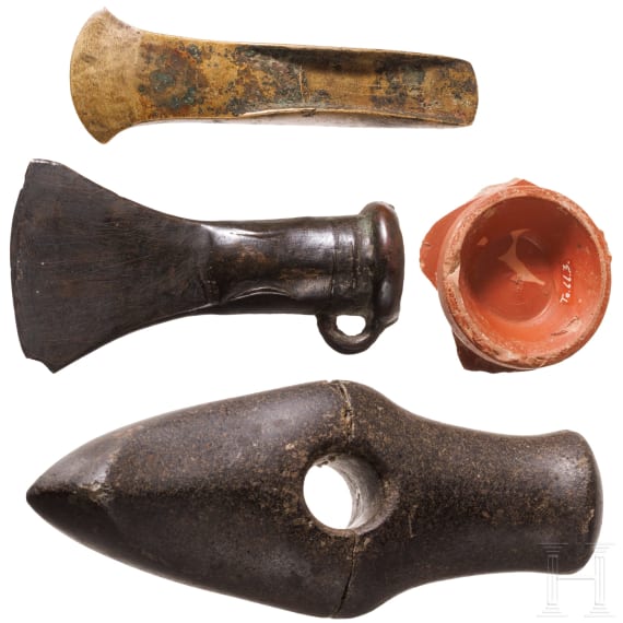 A stone axe, a flanged axe and a socketed axe, Copper Age and Bronze Age, mid-3rd millennium to 8th century B.C., plus a terra sigillata base with stamp