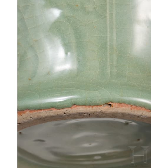 A Chinese molded Longquan celadon jar, probably Yuan Dynasty