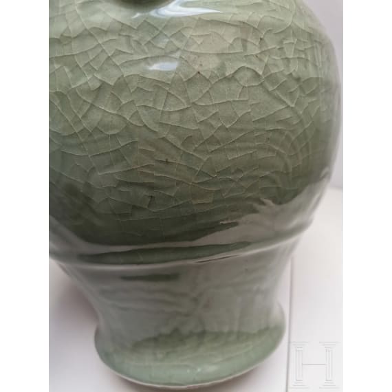 A Chinese molded Longquan celadon jar, probably Yuan Dynasty