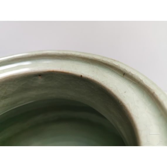 A Chinese molded Longquan celadon jar, probably Yuan Dynasty