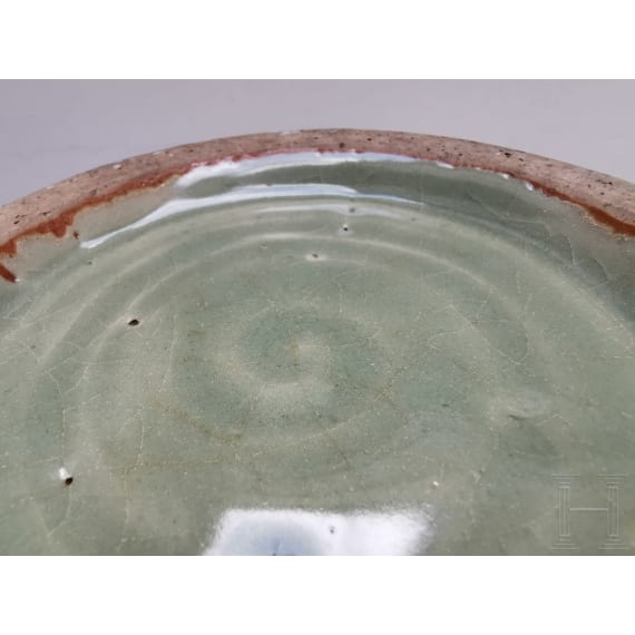 A Chinese molded Longquan celadon jar, probably Yuan Dynasty
