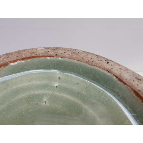 A Chinese molded Longquan celadon jar, probably Yuan Dynasty