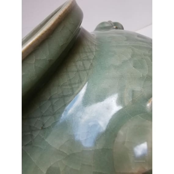 A Chinese molded Longquan celadon jar, probably Yuan Dynasty