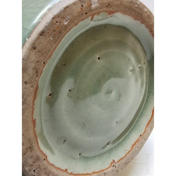 A Chinese molded Longquan celadon jar, probably Yuan Dynasty