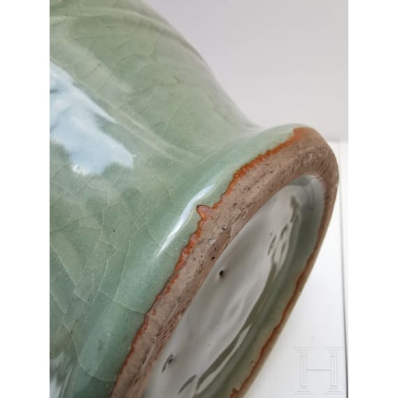 A Chinese molded Longquan celadon jar, probably Yuan Dynasty