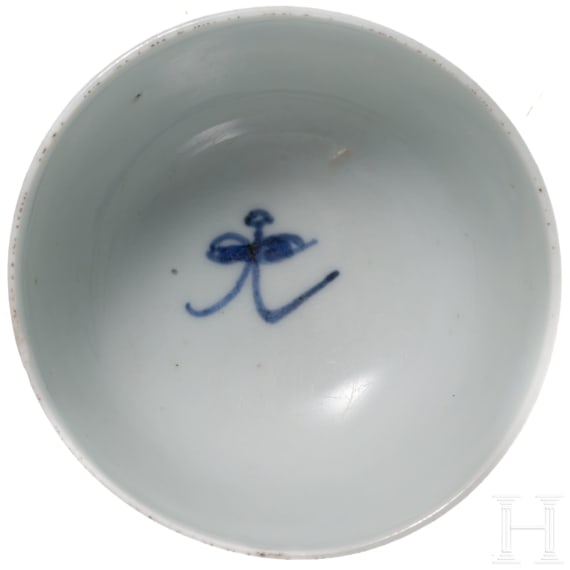 A Chinese blue and white cup and a small plate with wooden stand, Kangxi period, circa 1700