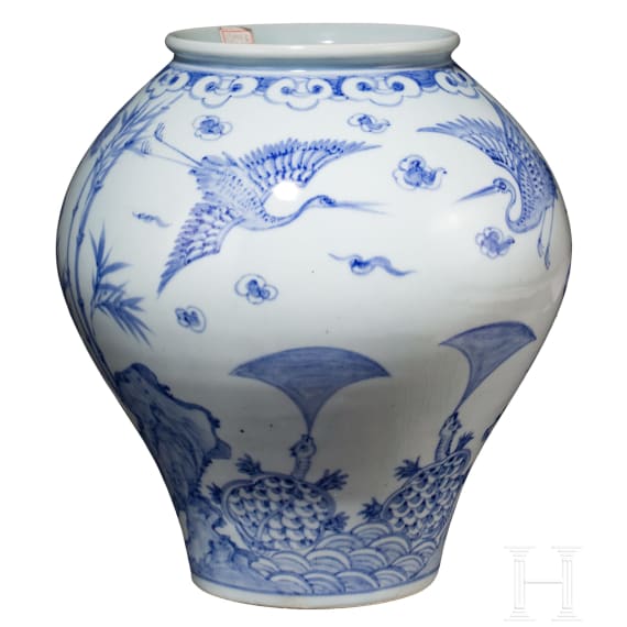 A Korean porcelain vase and a Chinese wooden dragon, 20th century