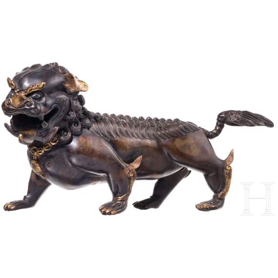 A Chinese bronze of a striding guardian lion, circa 1900