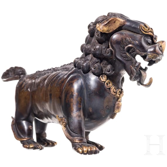 A Chinese bronze of a striding guardian lion, circa 1900