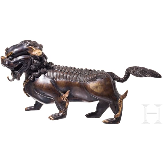 A Chinese bronze of a striding guardian lion, circa 1900