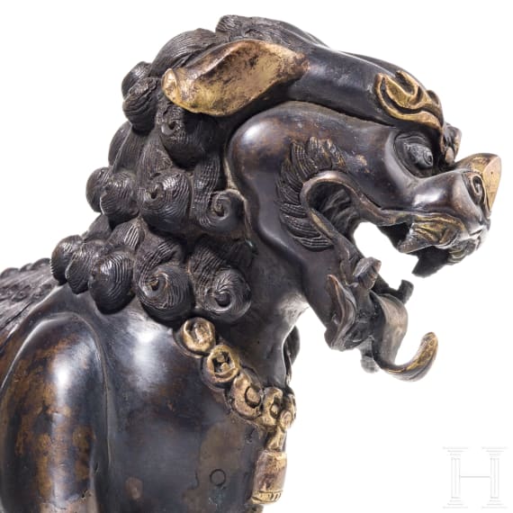 A Chinese bronze of a striding guardian lion, circa 1900