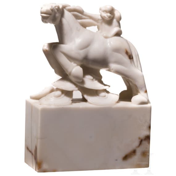 A Japanese marble Netuske carving of a monkey on a horse, probably 1900