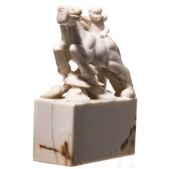 A Japanese marble Netuske carving of a monkey on a horse, probably 1900