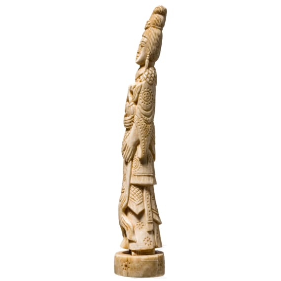 An ivory figure showing a woman with fruits, probably Indian, circa 1900