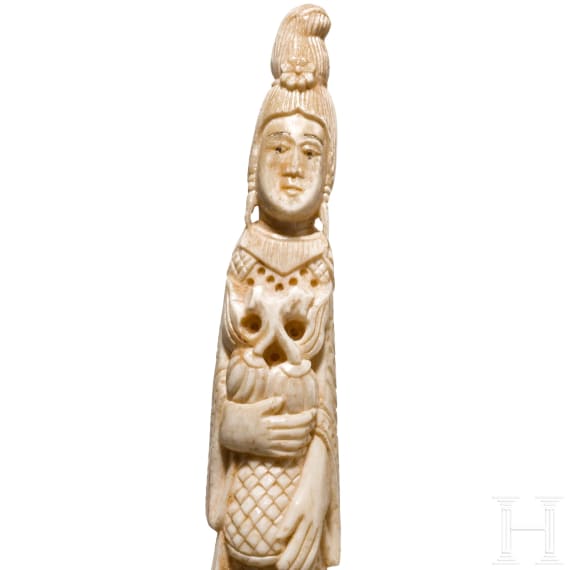 An ivory figure showing a woman with fruits, probably Indian, circa 1900