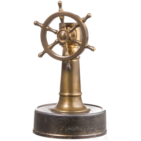A German brass steering wheel-shaped cigar cutter, circa 1900