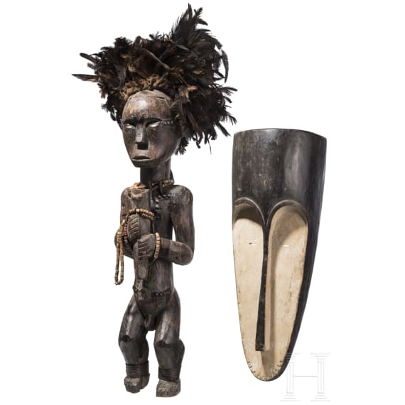 A Gabonese reliquary guardian figure and a Ngil-mask of the Fang people