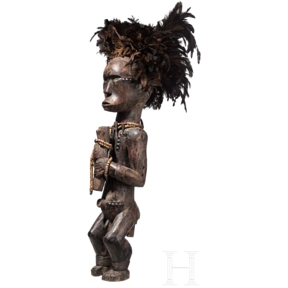 A Gabonese reliquary guardian figure and a Ngil-mask of the Fang people