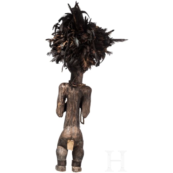 A Gabonese reliquary guardian figure and a Ngil-mask of the Fang people